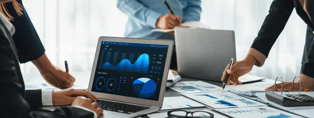 Business professionals reviewing reporting dashboards and analytics data during a team planning session