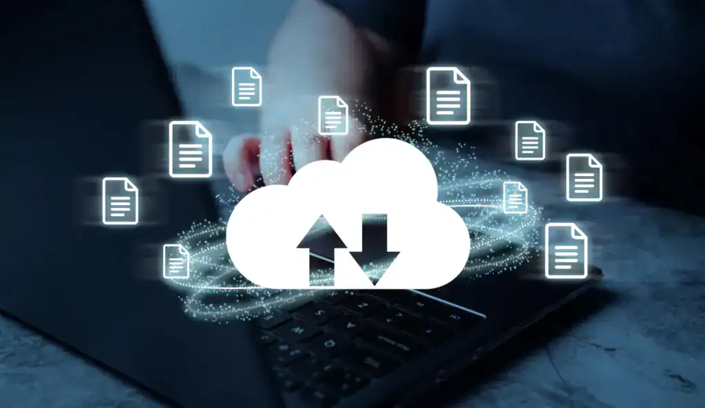 Cloud storage icon with upload and download arrows and document icons above a laptop keyboard.