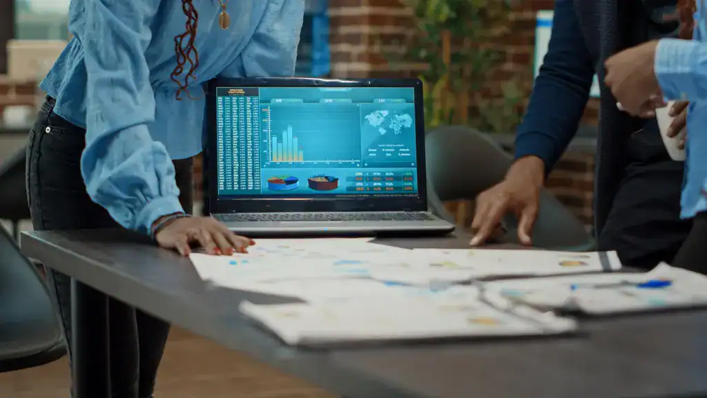Team members reviewing reports, dashboards, and business performance data during a planning meeting