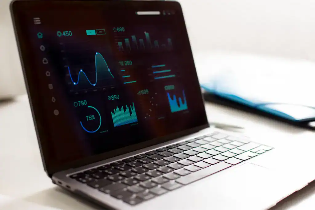 Laptop displaying a business analytics dashboard with charts and performance metrics