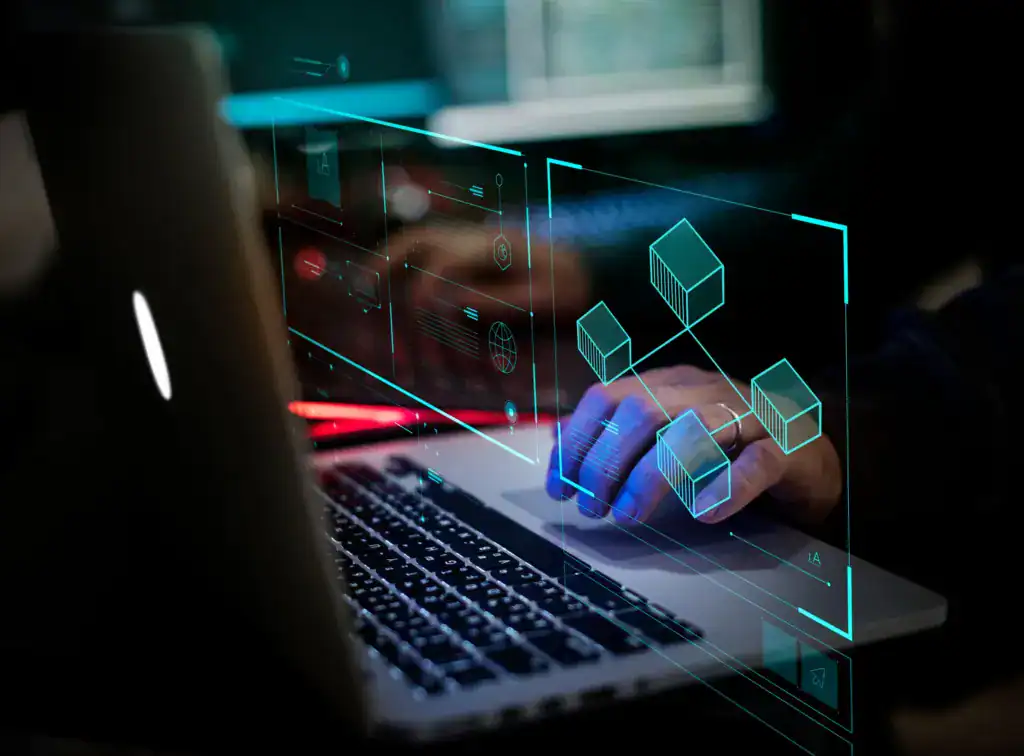 Professional using a laptop with a digital graphic representing connected data systems
